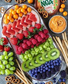 fruit platter with pretzels, kiwis, strawberries, oranges and grapes