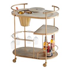 a bar cart with wine glasses and bottles on it's wheels, holding drinks