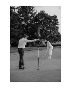 two people are playing golf on the court