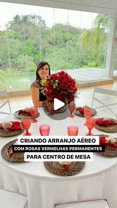 a woman sitting at a table with plates and cups