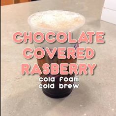 there is a cold drink in a plastic cup with whipped cream on top and the words chocolate covered rasberry