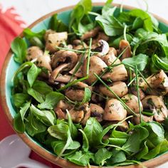 a bowl filled with spinach and mushrooms