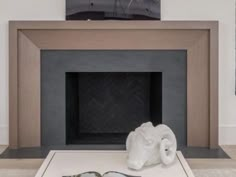 a towel and two pairs of slippers are on the floor in front of a fireplace