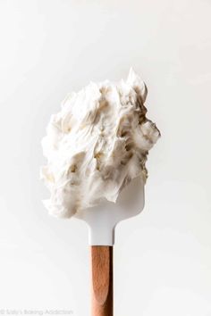 whipped cream on top of a wooden spoon