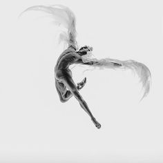 a woman is flying through the air with white feathers