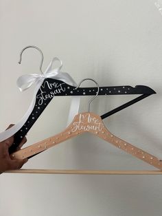 a person is holding two wooden hangers that say mr and mrs