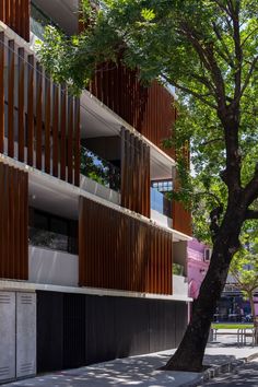 an apartment building with wooden slats on the sides