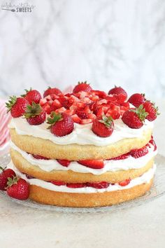 a cake with strawberries on top and frosting