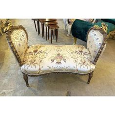 an ornately upholstered chaise lounge chair