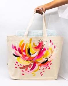 This tote bag is a functional piece of art that is perfect for holding all your travel essentials in style! Made from durable heavyweight 100% cotton canvas, it features a unique 3D embroidered "S.Ford" signature and has a roomy 37 liter capacity. With playful and quirky designs by Suze, including her signature painting, this bag is sure to add a touch of luxury and personality to your wardrobe. And don't forget to sponge clean it - one-of-a-kind pieces like these deserve special care! 56 x 41 x 16cm Cotton Tote Weekender Bag For Weekend Trips, Cotton Travel Tote Bag With Canvas Lining, Cotton Travel Tote With Canvas Lining, Cotton Canvas Tote Bag For Weekend Trips, Eco-friendly Canvas Bag For Weekend Trips, Large Cotton Canvas Bag, Artsy Cotton Bags For Everyday, Artsy Canvas Bags For Everyday, Artistic Large Capacity Canvas Travel Bag