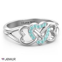 a white gold ring with two hearts in the middle and diamonds on each side,