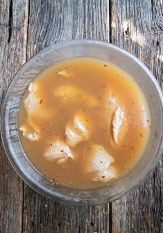 a bowl filled with soup sitting on top of a wooden table