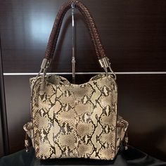 Nwt- Rare - A Collectors Dream Bag. Stunning Python Snake Skin Shoulder Bag By Michael Kors. Soft And Supple Snake Skin With A Brown Leather Braided Shoulder Straps, Outer Side Pockets, And Magnetic Closure. Wear It Casual With Jeans Or To Make Any Outfit Pop..!! Approximately 12”W X 10”H X 6”D With A 10” Drop. Purchased At Saks In 2010 And Never Used. Comes With Dust-Bag And Original Tags. This Is A Bag You Don’t Want To Miss Out On Owning.!!!! Python Bags, Dream Bag, Python Snake, A Bag, Michael Kors Bag, To Miss, Michael Kors Monogram, Magnetic Closure, Python