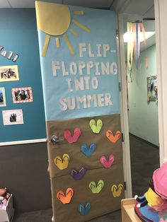 a bulletin board with the words flip flopping into summer on it in an office hallway