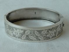 "Victorian solid sterling silver hinged cuff bracelet, hallmarked Birmingham 1887  makers mark R probably R.Bs for Rolason Brothers, manufacturing jewellers & silversmiths, Vyse Street, Birmingham. Fine hand engraved floral decoration. The strong hinge and clasp make this highly collectable bangle very wearable. Will fit a medium size wrist, inside the oval measures 2,3/8\" x 1,3/4\" or 60mm x 46mm, intrnal circumference 6,9/16\" or 167mm Width of bangle 11/16\" or 17mm, weight 19 grams. In good Luxury Engraved Sterling Silver Ornate Bracelet, Luxury Engraved Antique Silver Sterling Bracelet, Custom Bangle, Silver Cuff Bangle, Engraved Cuff, Bracelet Box, Gold Aesthetic, Cuff Bangle Bracelet, Floral Decoration