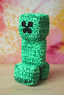 a green crocheted toy sitting on top of a table