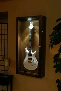 an electric guitar is in a case on the wall