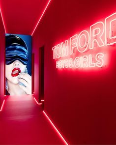 a red room with neon lights and an image of a woman's face on the wall