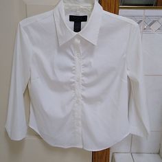 White Express Button Down Blouse, 3/4 Sleeves, Shirring In Front, Polyester, Nylon, Lycra Spandex Fitted Formal Shirt With 3/4 Sleeve, Fitted Half-sleeve Blouse With Buttons, Fitted Half Sleeve Blouse With Buttons, White 3/4 Sleeve Top With Button Closure, White Fitted Shirt With 3/4 Sleeves, Fitted White Shirt With 3/4 Sleeves, White Shirt With 3/4 Sleeves And Button Closure, White Ruffle Top, Overlay Blouse