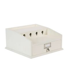 a white box with four compartments on the bottom and one drawer open to show two keys