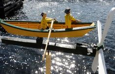 two people in a small boat on the water