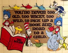 the dr seuss sign is hanging on the wall in front of some children's books