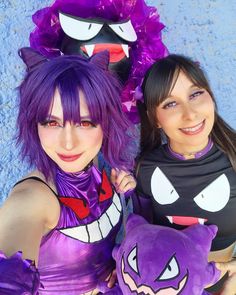 two women dressed in costumes posing for a photo