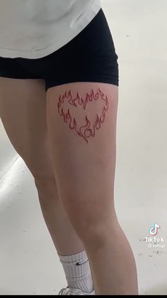 a woman's legs with tattoos on them and the word love written in red ink