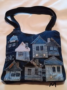 a handbag made out of old jeans with small houses on the front and sides