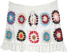 a white crocheted skirt with multicolored flowers on the front and bottom