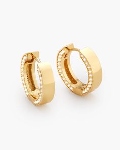 Level up with these sophisticated pavé hoops. Our men’s gold Studded Frame Hoop Earrings have 96 exquisitely handset diamond simulants in the 14k gold and 925 sterling silver setting. These sleekly designed hoops will show everyone you have impeccable style. Luxury Gold Huggie Earrings Channel Set, Classic Gold Hoop Earrings With Pave Setting, Luxury Yellow Gold Channel Set Huggie Earrings, Modern Gold Hoop Earrings With Pave Setting, Luxury Channel Set Hoop Huggie Earrings, Luxury Channel Set Huggie Hoop Earrings, Luxury Huggie Hoop Earrings Channel Set, Luxury 14k Gold Hoop Earrings With Pave Setting, Mens Earrings Hoop