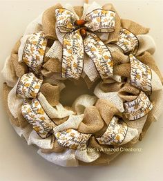 a burlock wreath with words on it and an orange bow hanging from the front