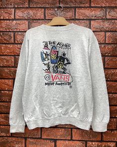 "Vintage 80s Vans Native Skateboard Pullover T Shirt / Old Skates T Shirt / 90s Vibe / 90s Streetwear / Made In Usa Size L Condition : Good Used Size on tag : L Colour : Grey Brand : Vans Measurement : Armpit to armpit - 22\" Length - 24\" Material : Old Cotton Made In: Usa THE SHIPPING (Your Choice Please read) 1. The shipping cost is USD 20 via Malaysian Registered Postage With Tracking Number. It will take 2-4 weeks or more for delivery, depends on your custom checking. 2. Add USD 10 for spee Trendy Graphic Print Tops For Skateboarding, Urban Crew Neck Tops For Skateboarding, Casual Skateboarding Top With Front Print, Casual Crew Neck Sweatshirt With Graffiti Print, Casual Tops With Front Print For Skateboarding, Casual Front Print Tops For Skateboarding, Casual Long Sleeve Tops For Skateboarding, Casual Tops With Graffiti Print For Skateboarding, Casual Graffiti Print Tops