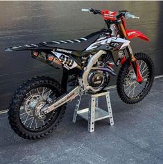 a dirt bike parked on top of a metal stand