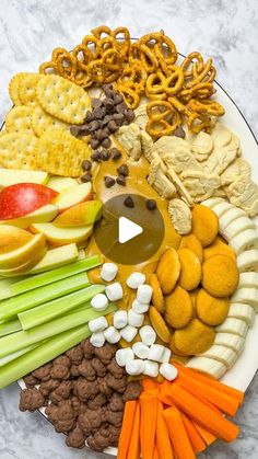 a platter filled with different types of food on top of a marble countertop