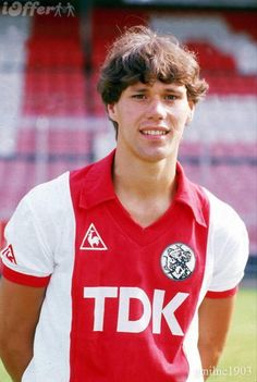 a young man in a red and white soccer uniform