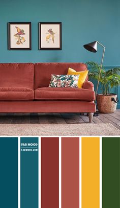 a living room with blue walls, red couch and green plant in the corner color scheme