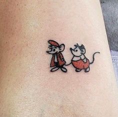 a small cat and mouse tattoo on the ankle