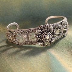 "Created from original vintage tools and dies, this bracelet has the appearance of the finest Spanish lace. A stunning bracelet for brides, bridesmaids, wedding party and Mother of the Bride. Fabricated by hand and torch, one delicate panel at a time is secured around the open cuff. Size: 7\" Made in our Los Angeles, CA studio. Contact us for bulk pricing and wholesale information." Vintage Oxidized Bracelet Jewelry, Antique Oxidized Bracelet, Vintage Metal Bangle With Oxidized Finish, Vintage Oxidized Bangle For Weddings, Vintage Silver Bangle With Oxidized Finish, Formal Cuff Bracelet With Intricate Design, Heirloom Wedding Bracelets With Intricate Design, Anniversary Filigree Bangle Bracelet, Anniversary Filigree Bangle Bracelets