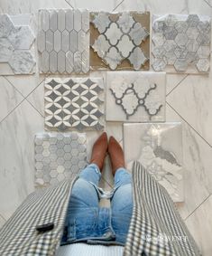 a person laying on the floor surrounded by tiles