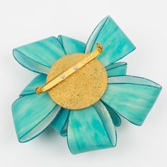 This is part of Chairish’s Costume Jewelry assortment.  This exquisite brooch from Cilea Paris is a piece of art to wear, crafted by hand with skillful attention to detail. Made with high-quality resin, it features a beautiful turquoise ribbon design that creates a stunning visual impact. The brooch is signed with the name "Cilea" on the clasp and is secured with a reliable closing clasp. It is a magnificent statement piece that will impress and make a lasting impression. Measurements: 3.75 in diameter (9.5 cm) x 1.07 in deep (2.7 cm).  Please see the measurements noted above in the description for the best approximate dimensions. Luxury Turquoise Brooches, Luxury Turquoise Brooches For Gift, Handmade Turquoise Brooches For Gift, Handmade Turquoise Brooches As Gift, Turquoise Resin, Bakelite Brooch, Ribbon Pin, Art To Wear, Ribbon Design