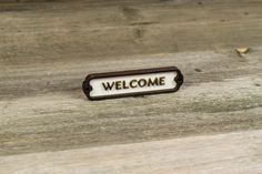 a bathroom sign sitting on top of a wooden floor