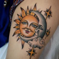 a sun and moon tattoo on the thigh, with stars in the sky around it