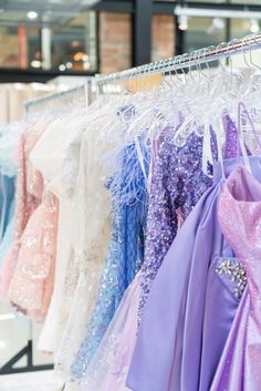 Homecoming dresses showcased on a clothing rack.