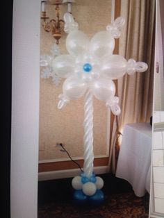 an inflatable balloon tree with blue and white balloons on it's base