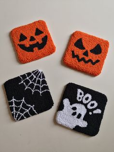 three halloween coasters with black and orange designs