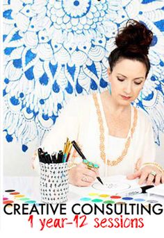 a woman sitting at a table writing on paper