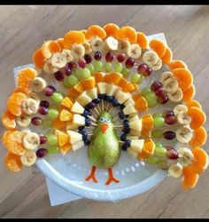 a turkey made out of fruit on top of a white plate