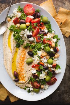 a white plate topped with salad and pita bread