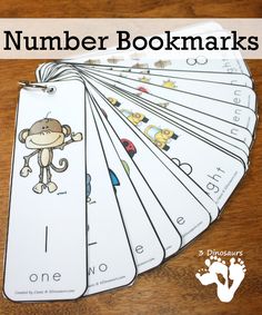 the number bookmarks are arranged on a wooden table with an image of a monkey